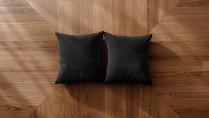 Pair of black cushions placed on sleek wooden surface, ideal for layout backgrounds or editorial headers