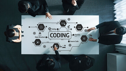 This image captures a dynamic meeting focused on coding concepts, showcasing professionals collaborating around a table with digital graphics and flow diagrams enhancing the creative process. Amity