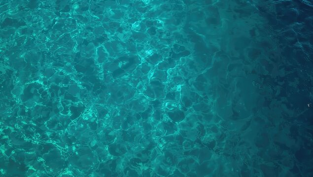 Aerial shot of vibrant turquoise sea with gentle ripples, suitable for layout backgrounds, World Ocean Day