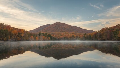 Fototapeta premium Autumn scenery in Petit Jean State Park showing fall colors, mountains, and orange foliage reflecting in the sky