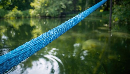 Fish cage construction with blue netting, highlighting aquaculture equipment