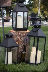 Three candle lanterns in a garden