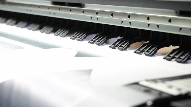 Industry printer. High quality Industrial inkjet printer in operation. printing patterns on large sheet of fabric or paper. Automate printer for modern textile printing and digital print technology.