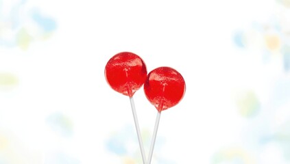Pair of hard candy lollipops with vibrant red hues, ideal for promotional displays or decorative purposes, National Candy Month