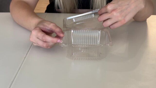 Handling Food Packaging With Care, Woman Carefully Unsealing Transparent Food Tray With Her Fingers