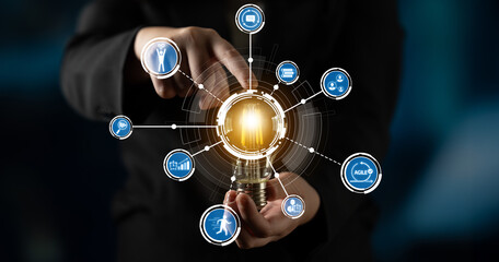 A businessman presents a light bulb surrounded by various icons, symbolizing creativity and...