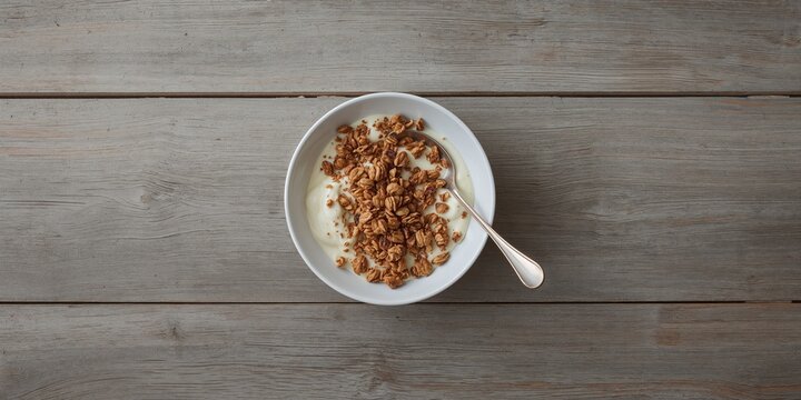 Yogurt with homemade granola served on a wooden table, suitable as a breakfast background, Earth Day