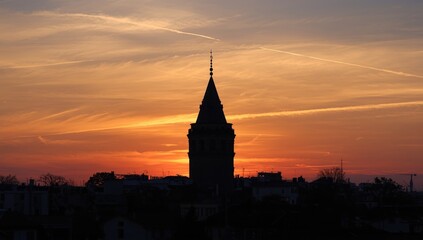 Fototapeta premium Galata Tower at dusk with vibrant sunset colors, suitable as a scenic background for layouts, Earth Day