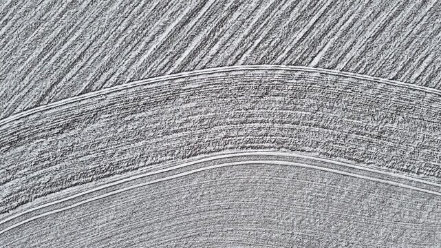 Aerial view.  Agricultural fields.  Crop circles.  Aerial photography.  Farming.  Rural landscape.  Top view.  Harvest.  Pattern.  Texture.  Black and white.  Aerial shot