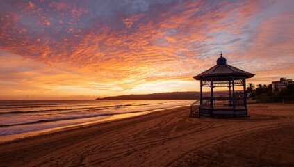 Oceanfront band stand featuring a rustic wooden canopy and seating area, used for outdoor concerts and gatherings, summer