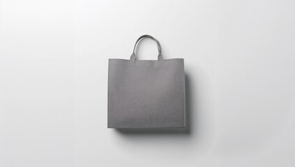 Plain gray shopping bag on white surface serving as a background for product presentation and branding