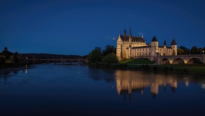 Fototapeta premium Nighttime view of a illuminated castle in a serene environment, focusing on lighting and structure details