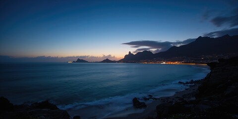 Night view of Camps Bay and Oudekraal from Clifton, capturing city, beach, and water landscape at dusk, urban coastal scenery