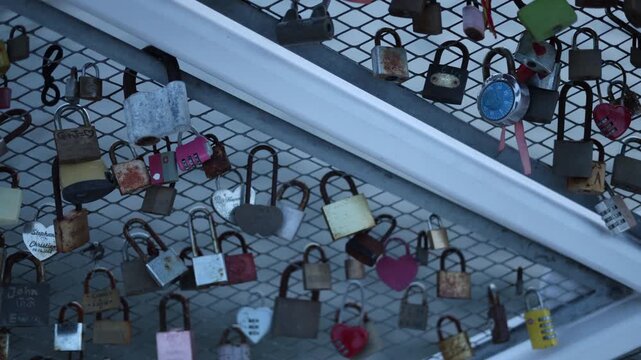 Close up love locks attached to bridge railing romantic couples names wedding concept relationship and symbolic commitment