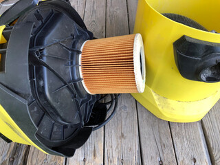 Yellow vacuum cleaner, old vacuum cleaner for cleaning the house, in disassembled condition.