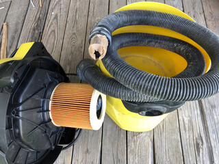Yellow vacuum cleaner, old vacuum cleaner for cleaning the house, in disassembled condition.