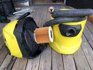 Yellow vacuum cleaner, old vacuum cleaner for cleaning the house, in disassembled condition.