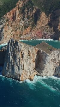 Aerial shot of Pan di Zucchero near Masua, Sardinia, rising from the Mediterranean with steep white cliffs, calm waves,