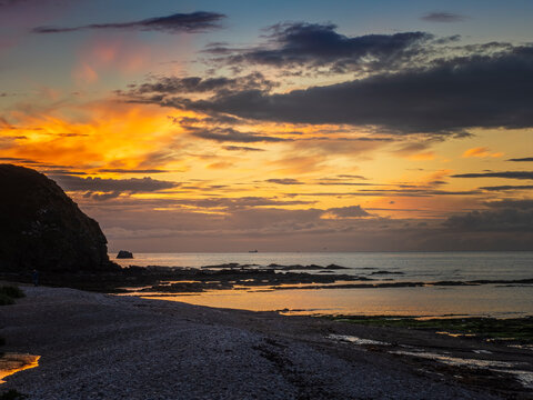 Fraserburgh Scotland beach sunset with dramatic clouds reflecting on water