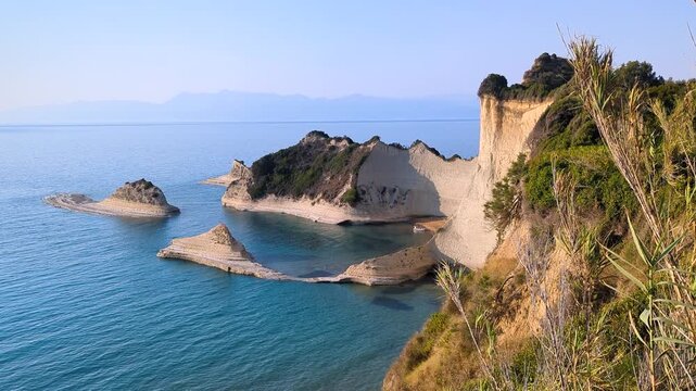 View of beautiful islands of unique shape on Cape Drastis. One of main attractions of Corfu (Kerkyra) island. Greece. Turquoise Ionian Sea around limestone rocks. Magnificent coastal landscape.