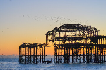 UK, Brighton, 03.01.2026: Burnt out Brighton Pier during sunset