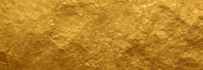 Close-up shot of gold textured surface with criss-cross pattern and warm golden hue
