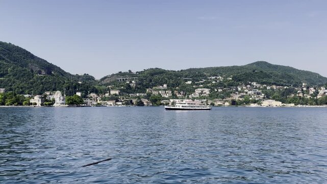 Passenger boat on Lake Como with Villa Olmo and Tempio Voltiano in background