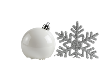 Macro close-up of a matte white christmas bauble beside a shimmering silver snowflake nestled in soft crystalline snow against a transparent high-key background, minimalist holiday elegance concept