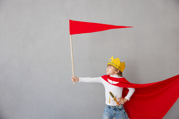 Child pretend to be knight. Kid having fun at home