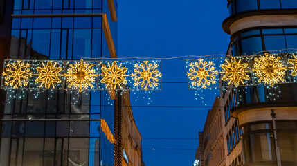 Beautiful snowflake decorations illuminated during a winter evening in Wroclaw. The lights create a festive atmosphere, perfect for holiday celebrations and events in urban settings.