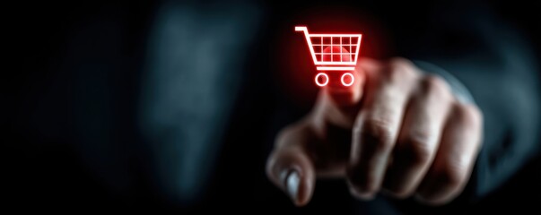 Businessman touches a red digital shopping cart icon, symbolizing online shopping and ecommerce