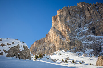 Winter Outdoor Scenery with Rocky Peaks in Northeastern Italy. Snow Covered Landscape during Sunny Day with Clear Blue Sky in Dolomites.