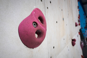 Colorful grips on a climbing wall. Sports and recreation.
