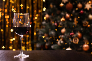 A glass of red wine with bokeh background for Christmas