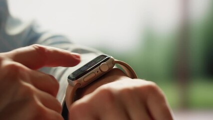 Smart watch using in office, Successful asian businessman use smartwatch at workplace, man chooses apps and smile happy with apps, employee inside office use laptop at work. - Powered by Adobe