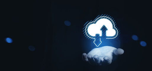 Hand holding glowing cloud icon with upload and download arrows, symbolizing online data storage and remote network access concept on dark background.