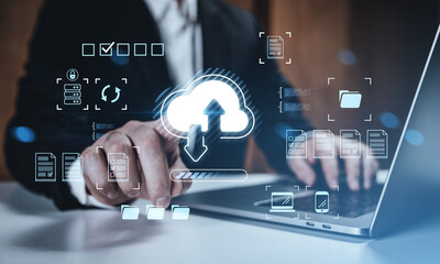 Businessman interacting with cloud storage interface on laptop, showcasing online data management and remote network access concept hologram.