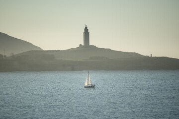 paisaje en el mar con un barquito y la torre de hercules  © Jimmy