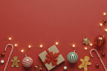 Festive red background with holiday decorations and gift