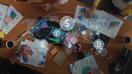 A diverse group of professionals collaborates at a wooden table, analyzing financial data and discussing cryptocurrency trends in a modern office environment. Raster - Powered by Adobe