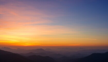 Obraz premium Early Morning Light Sky Before Sunrise Vivid Warm Yellow Orange And Brown Light On Mountainous Horizon Panoramic Sky With Colorful Pastel Tone Colors For Background