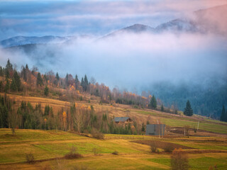fog in mountains with pink light of sunrise