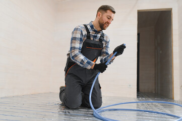 Water underfloor heating systems installation, work in progress on construction site for a modular house