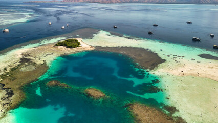 Scenic aerial landscape of Pulau Karangan Komodo highlighting coral reef and clear tropical sea