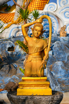 The golden statue of Phra Mae Thorani wringing her hair at Wat Tha Ton in Mae Ai valley, Northern Thailand
