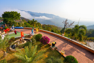 Panoramic mountain view with morning mist and the Kok River at Wat Tha Ton, a modern hilltop buddhist temple in Mae Ai District, Chiang Mai Province, Northern Thailand