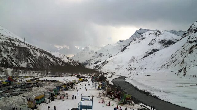 Cinematic aerial pull-away shot of a mountain zipline station near Koksar, the gateway to Lahaul Spiti valley