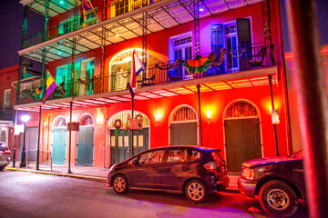 Urban night scene in New Orleans showcasing streets alive with Mardi Gras colors © jovannig