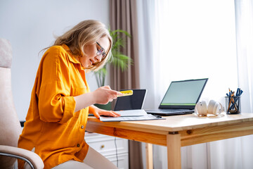 Legal consultant woman preparing documents at home office. Freelance law advisory and organized remote workspace.