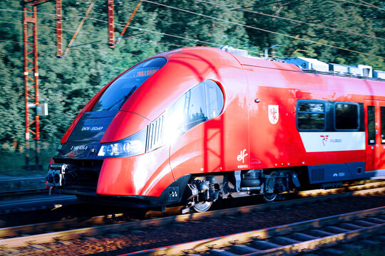 Torun, Poland - July 2, 2025. Pesa Elf electric multiple unit train of Polregio moving fast with intentional panning motion blur.
